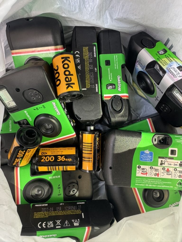 A pile of used disposable cameras