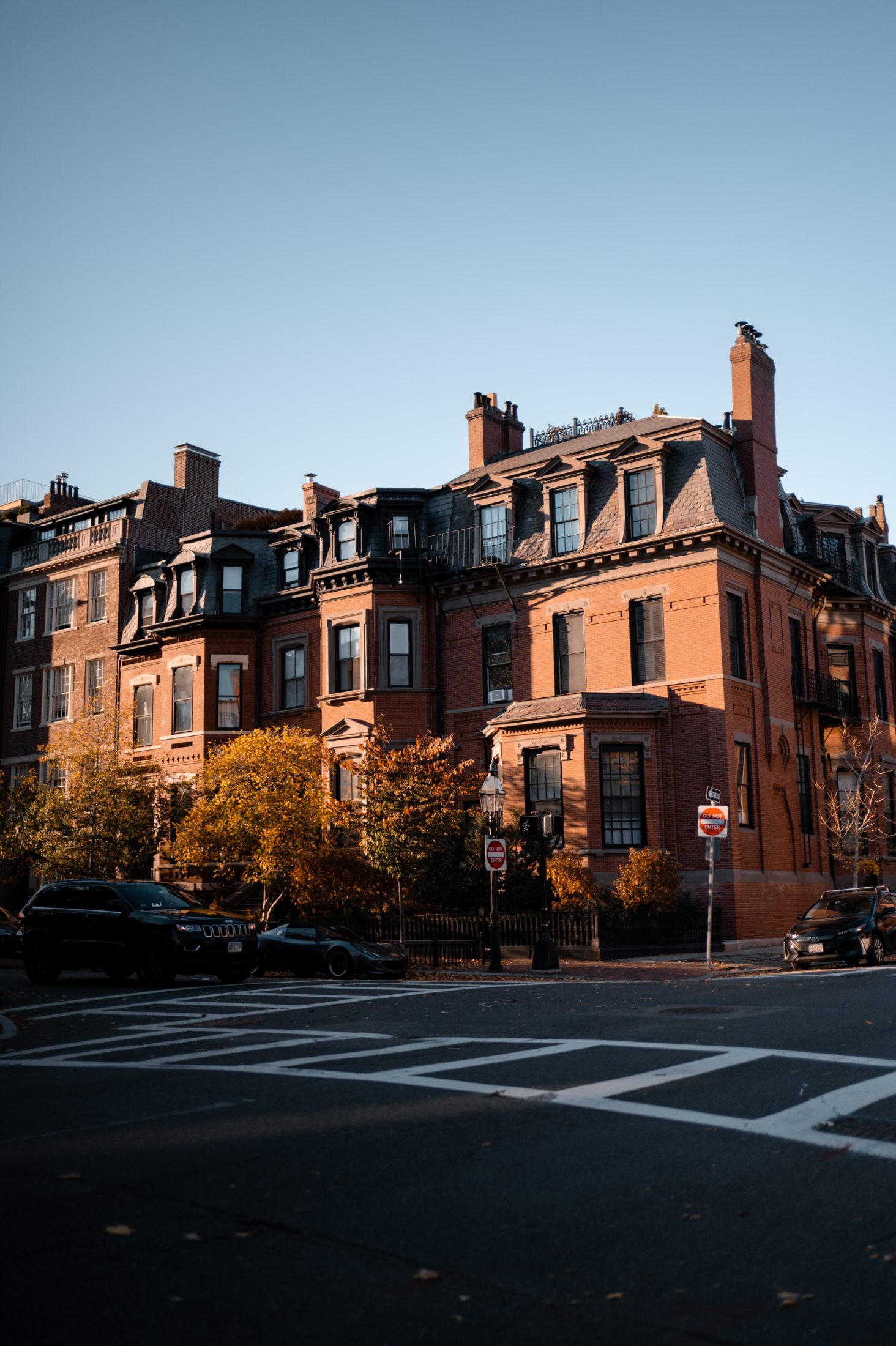 A red-brick Back Bay corner building in late afternoon light